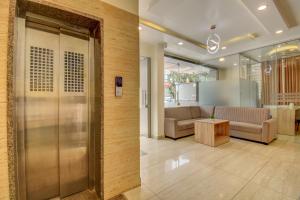 an office lobby with a couch and a table at Le Mysuru Palace in Mysore