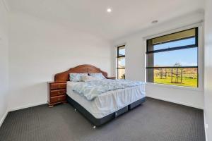 Ένα ή περισσότερα κρεβάτια σε δωμάτιο στο Modern Retreat 3BR Family Home