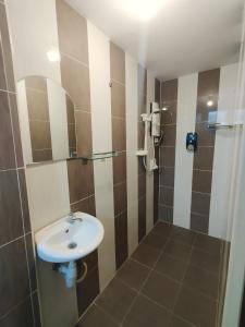 a bathroom with a sink and a shower at J Hotel Masjid India KL in Kuala Lumpur +31 photos