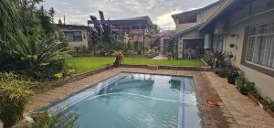 a swimming pool in the backyard of a house at Upstairs R-4 Self Catering Unit in White River