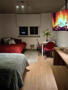 a bedroom with a bed and a desk and a table sidx sidx sidx at Departamento Barcelona in Temuco