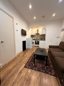 a living room with a couch and a table at Caledonian Apartment in Edinburgh
