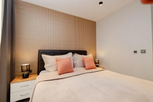 a bedroom with a large bed with orange pillows at Istanbul Apartments in Istanbul