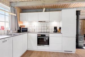 a white kitchen with white cabinets and appliances at 517-Thisted-Sigvej-10 in Thisted +16 photos