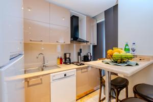 a kitchen with a sink and a bowl of fruit on a counter at Istanbul Apartments in Istanbul