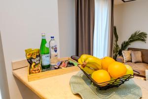 a table with a bowl of fruit and a bottle of alcohol at Istanbul Apartments in Istanbul