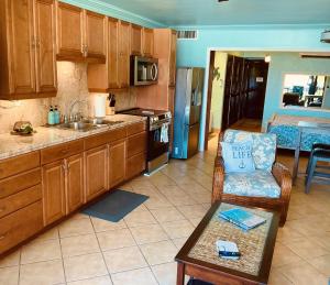 a kitchen with wooden cabinets and a chair and a table at C206 - Sapphire Beach - Sapphire Jewel VI in East End