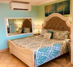 a bedroom with a large bed with a large mirror at C206 - Sapphire Beach - Sapphire Jewel VI in East End +21 photos