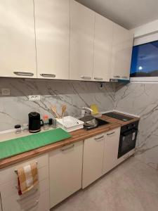 a kitchen with white cabinets and a counter top at Villa Georgi in Ohrid
