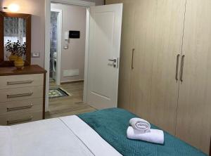 a bedroom with a bed with two towels on it at dorian beach appartment 4 in Durrës