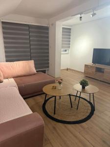 a living room with a couch and two tables at Villa Georgi in Ohrid