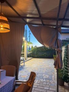 a patio with a table and chairs under a pergola at Villa Georgi in Ohrid