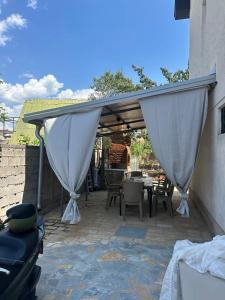 a patio with a white canopy and a table and chairs at Villa Georgi in Ohrid +13 photos