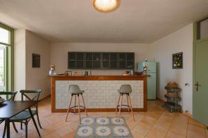 a kitchen with a fireplace and a table and chairs at Dimora delle Acque - Altavista Residence in San Nicola Arcella