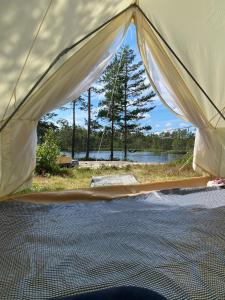 a tent with a view of a lake at Fredelig og landlig lavvoferie in Møkjåland