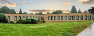 a building with a grass field in front of it at Alda Palas de Rei in Palas de Rei