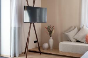 a floor lamp in a living room with a couch at Mendelglueck Apartments in Caldaro +28 photos