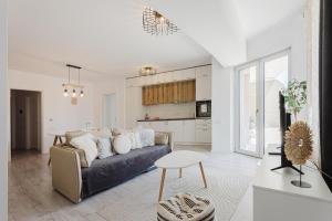 a living room with a couch and a table at City Center Accommodation - 108 in Reşiţa