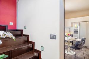 a room with a staircase and a kitchen with a table at La Maison de Elena Tuscany in Montepulciano