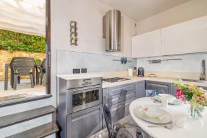 a kitchen with a table and a stove top oven at La Maison de Elena Tuscany in Montepulciano