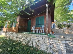 two chairs sitting on the porch of a house at Bunaglows Panoramic Beach Village in Balchik