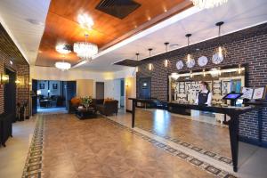 a lobby with a bar and a brick wall at Hotel Voyage in Belgorod