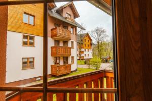 a view from a window of a building with balconies at VacationClub - Leśny Dom 16A Apartament 14 in Karpacz