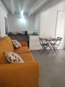 a living room with a couch and a table at Monolocale Zena in Carloforte +13 photos