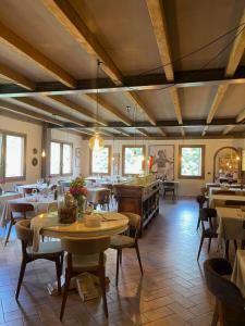 a restaurant with tables and chairs in a room at Hotel Gabriella in Fanano
