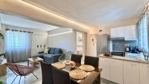 a kitchen and living room with a table and chairs at Free Spirit Nectar in Kalamata