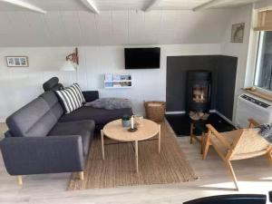 a living room with a couch and a fireplace at 1335-Vestervig-Spovevej-11 in Vestervig