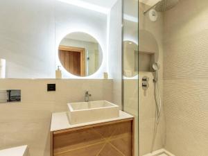 a bathroom with a sink and a shower with a mirror at Appart chic avec SPA, parking et WIFI - Les Arcs 1800 - FR-1-352-96 in Arc 1800 +23 photos