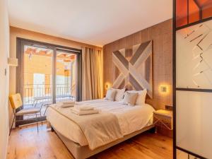 a bedroom with a large bed and a balcony at Appart chic avec SPA, parking et WIFI - Les Arcs 1800 - FR-1-352-96 in Arc 1800