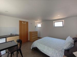 a bedroom with a bed and a desk and a bed sidx sidx sidx at Apulia Garden&Barbecue Suite in Apúlia