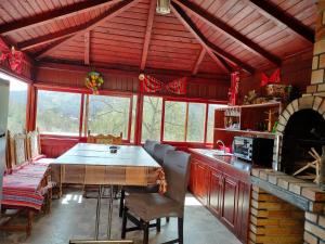 a kitchen with a table and chairs in a room at Casa Savu Secaria in Secăria
