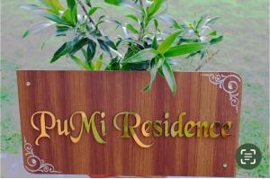 a wooden sign with a potted plant on it at PuMi Residence in Vānivilāsa Puram