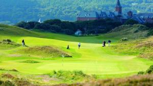 a group of people playing golf on a golf course at The Castle in Newcastle