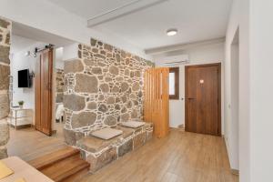 a living room with a stone wall and a couch at El Blanquizal A in La Aldea de San Nicolas