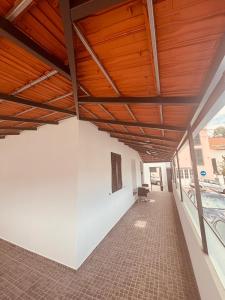 a room with a wooden ceiling and a white wall at Vila Ramos I in Funchal