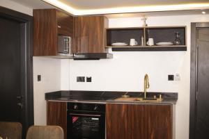 a kitchen with a sink and a stove at Kayla City in Kumasi