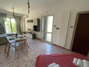 a living room with a table and a couch at Adele Garden in Taormina