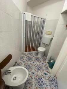 a bathroom with a toilet and a sink at Adele Garden in Taormina +31 photos