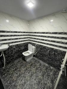 a bathroom with a toilet and a sink at Shivaay Residency in Varanasi +8 photos