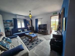 a living room with a couch and a table at Le petit paradis de Nicole in Villanueva de Algaidas