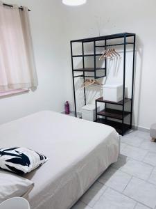 a bedroom with a bed and a rack of clothes at Le Costarelle Sabine in Torri in Sabina +1 photo