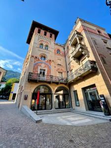 a tall building with a clock tower on a street at Torretta House in Locarno
