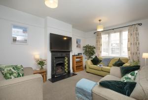 a living room with a couch and a fireplace at Withycombe in Seaton