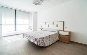 a bedroom with a bed and a desk and window at 1 Bedroom Stunning Apartment In Grao De Castellon in Grao de Castellón
