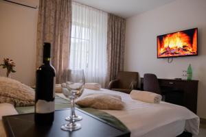 a room with a bottle of wine and a wine glass at Plitvice Inn in Jezerce