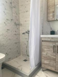 a white bathroom with a shower and a toilet at Maurizio's Villa in Yiáltra +73 photos